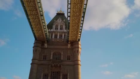 moving-hyperlapse-view-of-the-underside-of-the-upper-deck-of-Tower-Bridge-with-a-partly-cloudy-sky-in-the-background