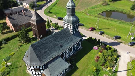 historic-half-timbered-church-high-angle-aerial-fly-away-sunny-day