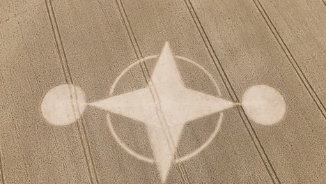 Curious-crop-circle-in-middle-of-dry-brown-farm-land,-Preston-Candover