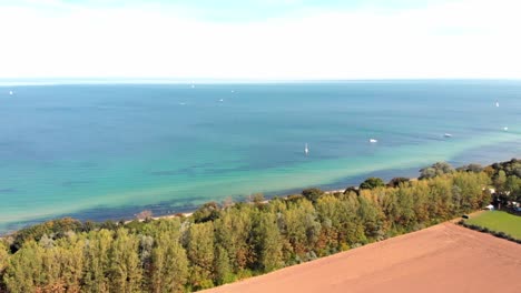 Aerial:-german-north-coast-in-Heiligendamm,-among-trees,-fields-and-the-sea