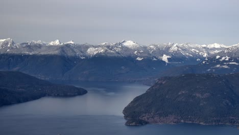 Aerial-View-of-Snowy-Mountain-Range-and-Lake---Bleak-Winter-Day