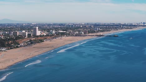 Drone-shot-panning-to-the-left-of-Santa-Monica-beach-and-pier-during-the-day