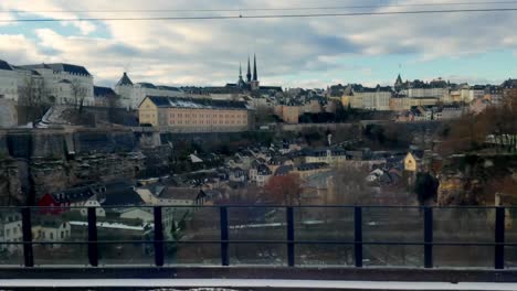 Experience-the-allure-of-Luxembourg-City-as-the-train-approaches,-with-a-stunning-view-of-the-Grund-below