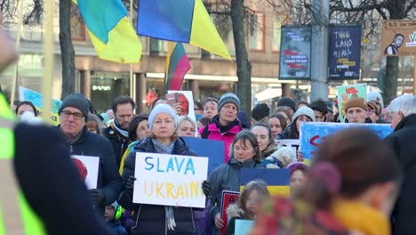 Woman-with-Slava-Ukraini-sign-at-protest-against-Russian-war,-slomo