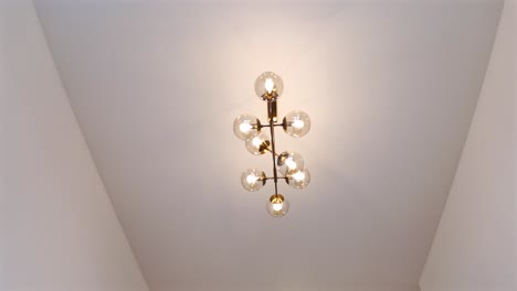 Luxurious-Interior-Chandelier-With-Lit-Bulbs-And-A-Light-Background