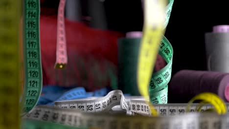 color-measure-tape-hang-black-background-slow-motion-dolly