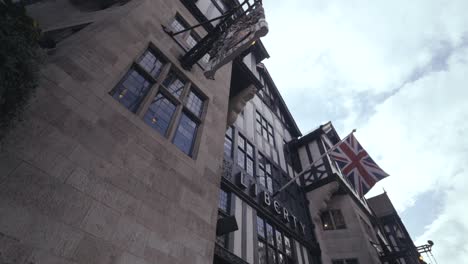 Liberty's-department-store-in-historic-Tudor-building,-with-English-flag