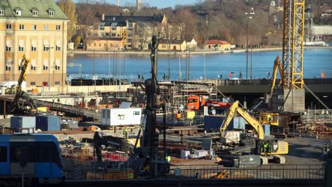 Subway-train-passes-by-construction-site-at-Slussen-in-sunny-Stockholm