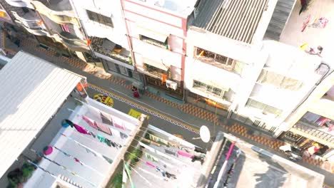 Aerial-Drone-View-Camera-Going-Forward-Where-Rangoli-Men-Of-Jay-Shree-Ram-On-Road-Between-Residential-Buildings-Are-Pictured