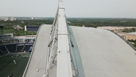 Aerial-Drone-Grey-Metal-Scaffolding-Roof-on-Massive-Sports-Arena-Stadium