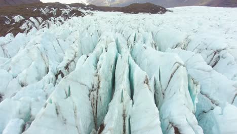 A-drone-4K-resolution-captures-stunning-aerial-footage,-presenting-unique-and-cinematic-views-of-Iceland's-glacier-covered-fields