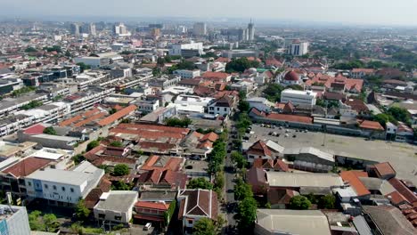 City-streets-and-buildings-of-Semarang,-aerial-drone-view