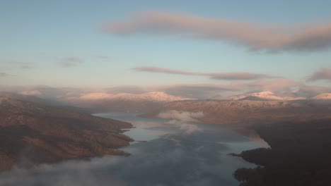 Static-shot-of-loch-Katrine-from-Ben-A'an-with-snowy-mountain-tops-at-winter