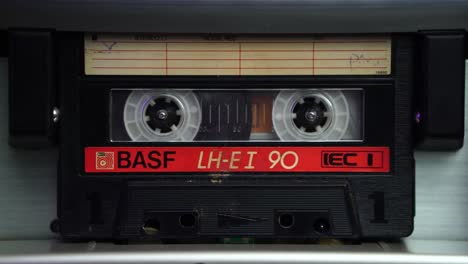 Inserting-Audio-Cassette-Tape-and-Starting-Playback-in-Vintage-Deck-Player,-Close-Up