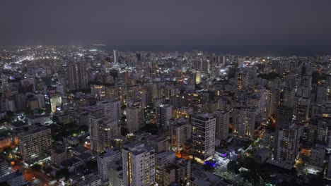 Night-aerial-view-of-illuminated-Santo-Domingo-skyline,-Dominican-Republic