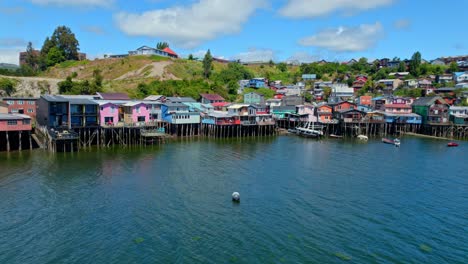 Luftpanorama-Meereslandschaft-Mit-Stelzenhäusern-In-Castro-Chiloé,-Chile,-Patagonische-Meeresinsel,-Natürliches-Reiseziel,-Farbenfrohe-Häuser-über-Wasser,-Drohnenaufnahme,-Südamerika