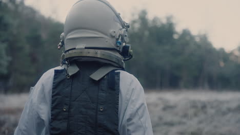Astronaut-in-space-suit-walking-trough-forest-clearing