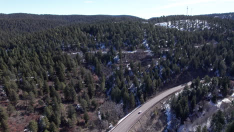 Cars-travel-along-a-road-on-a-mountain,-drone-aerial