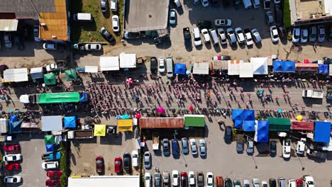 Wide-angle-top-down-bird's-eye-view-of-Carnaval-Grand-March-with-tent-shades-lining-street