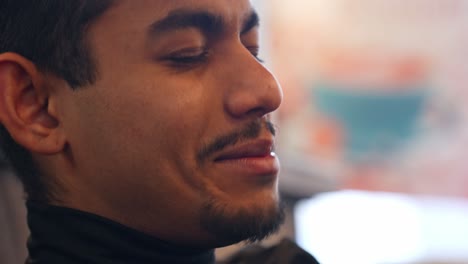 Extreme-close-up-portait-of-Sri-Lankan-man-talking-then-smiles,-profile-shot