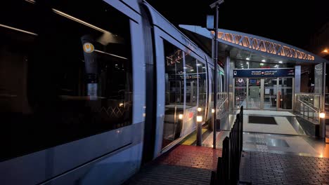 Dubai,-Emiratos-Árabes-Unidos,-Tren-De-Metro-Que-Llega-A-La-Estación-Por-La-Noche,-Sistema-De-Transporte-Masivo-De-La-Ciudad