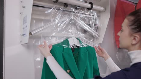 Female-Worker-Packing-Suit-With-Laundry-Clothes-Packing-Machine-After-Dry-cleaning