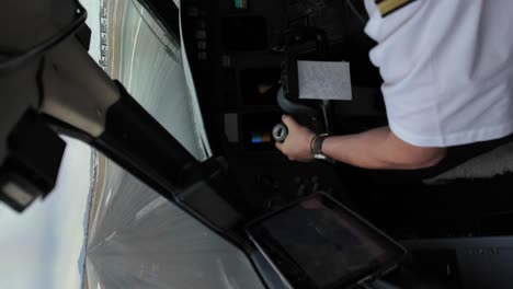 Left-shoulder,-arm-and-hand-of-a-white-pilot-during-takeoff-roll,-wearing-a-white-shirt-and-gallon