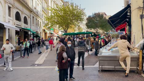 People-by-town-square-with-crowded-marketplace-in-Marseille,-France