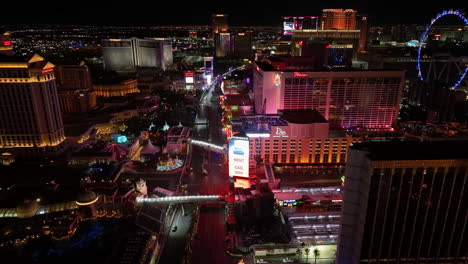 Drone-shot-overlooking-flashing-lights-at-the-strip,-nighttime-in-Las-Vegas,-USA