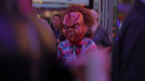 Person-in-Halloween-costume-of-Chucky-the-killer-doll-from-horror-film-in-crowded-public-place
