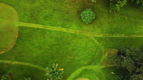 Top-down-drone-shot-over-a-Golf-course,-in-cloudy-Yaounde,-Cameroon,-Africa