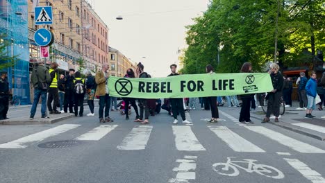 Protesters-with-banner-block-street-at-climate-demonstration-in-Sweden