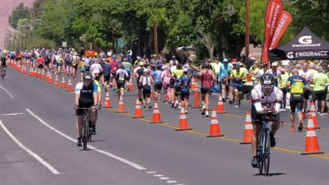 Zeitlupenaufnahme-Von-Radfahrern-Vorn-Und-Läufern-Im-Hintergrund-Beim-Intermountain-Health-Ironman-70