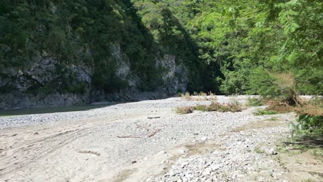 Drone-flying-at-low-altitude-on-riverbed-Muchas-Aguas,-San-Cristobal-in-Dominican-Republic
