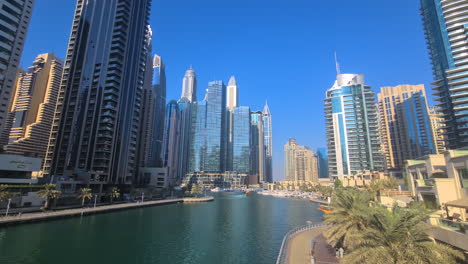 Dubai-UAE-Marina,-Skyscrapers-and-Towers-on-Waterfront,-Establishing-Tilt-Down-Shot