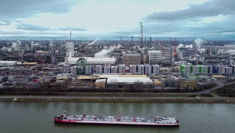 Emissions-and-Industrial-Shipping-Barge-at-Chemical-Plant-Complex,-Drone-View