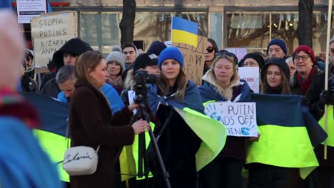 Slomo-of-photographer-and-protesters-with-Ukrainian-flags-in-Sweden