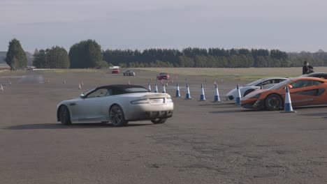 Multiple-supercars-racing-around-a-small-racetrack-in-scotland