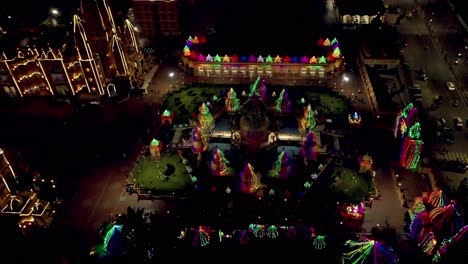 AERIAL-DRONE-VIEW-CAMERA-GOING-FORWARD-A-LARGE-TEMPLE-IS-SEEN-IN-THE-CENTER-THERE-ARE-VISIT-THE-LIGHTING-OF-THE-TEMPLE-AND-A-LOT-OF-PEOPLE-ARE-VISIT