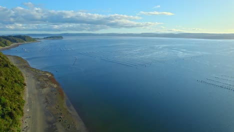 Aerial-Drone-Flyover-Scenic-Chile-With-Mass-Fishing-Nets-In-Ocean,-4K-Chiloe