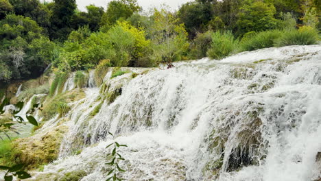 A-large-waterfall-roars-among-lush-greenery