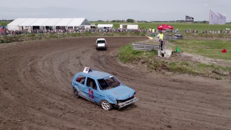 Aerial-view-of-old-cars-racing-on-dirt-track,-Friesland,-Netherlands