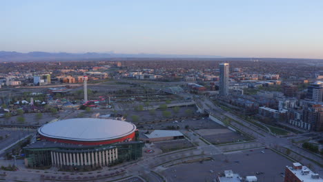 Summer-sunrise-Downtown-Denver-Colorado-city-landscape-aerial-cinematic-drone-i70-i25-traffic-first-light-golden-hour-sunset-South-Platte-River-REI-bridge-Ball-arena-glitches-forward-right-pan-motion