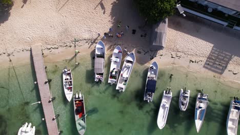 Overhead-view-take-off-several-boats-sport-fishermen-leaving-dock-ready-to-fish-caribbean-sea