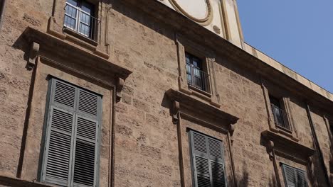 City-clock-on-the-wall-of-building-Palermo-Italy