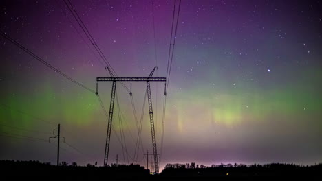 Timelapse-of-a-silhouette-power-pylon-with-vivid-Northern-lights-and-a-starry-sky