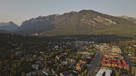 Banff-AB-Canada-Aerial-v22-cinematic-drone-flyover-residential-area-capturing-tranquil-morning-landscape-of-quaint-town-and-majestic-Sulphur-mountain-ranges---Shot-with-Mavic-3-Pro-Cine---July-2023