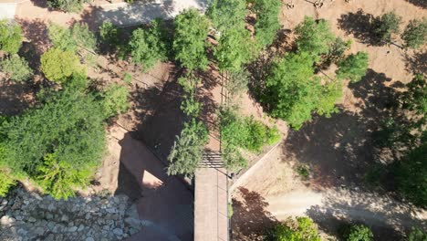 Top-view-aerial-perspective-of-the-bridge-and-Marmolejo-Spa-Center,-set-in-Jaén-province,-Andalusia,-southern-Spain