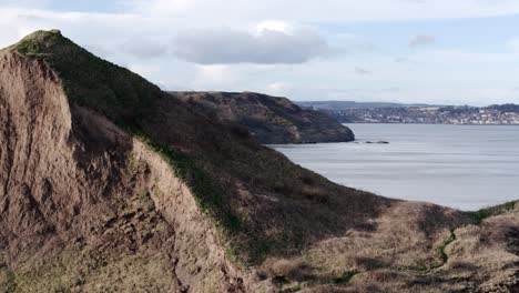 Dramatic-Aerial-reveal-footage-of-North-Yorkshire-coastline-with-Scarborough-town-in-the-distance