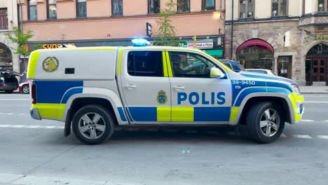 Swedish-Police-car-stands-still-on-street-with-sirens-on,-close-view